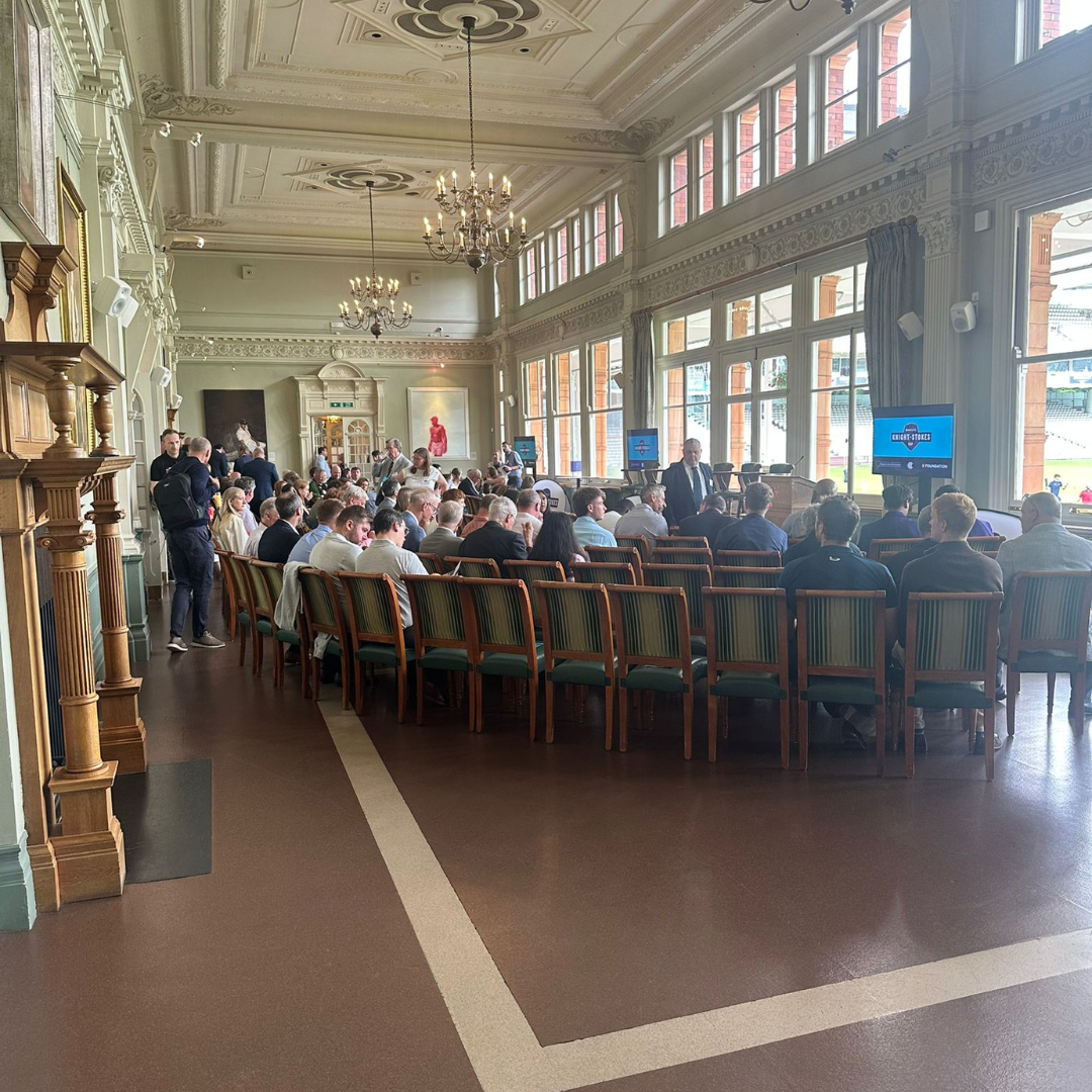 People gathered together in an indoor hall for a presentation