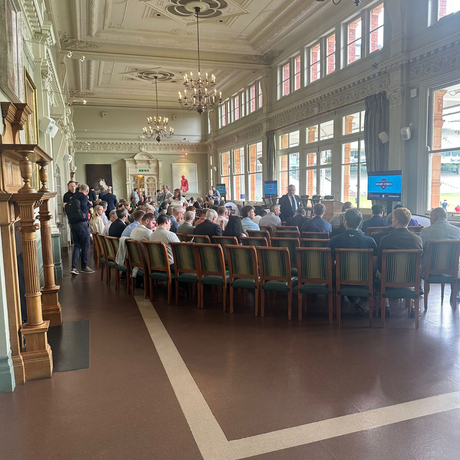 People gathered together in an indoor hall for a presentation