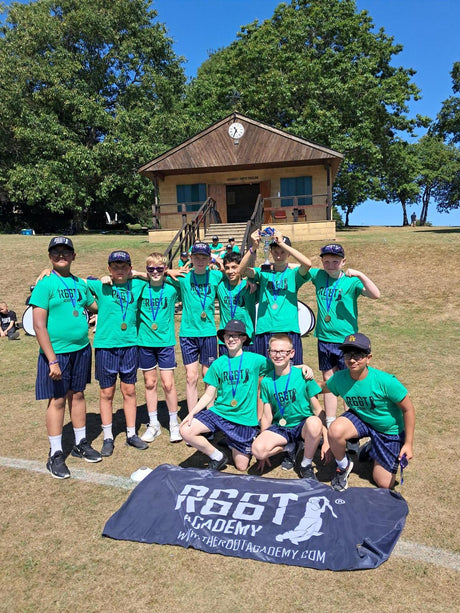 Players in green shirts with a R66T 2 Hardball logo holding a R66T Academy flag