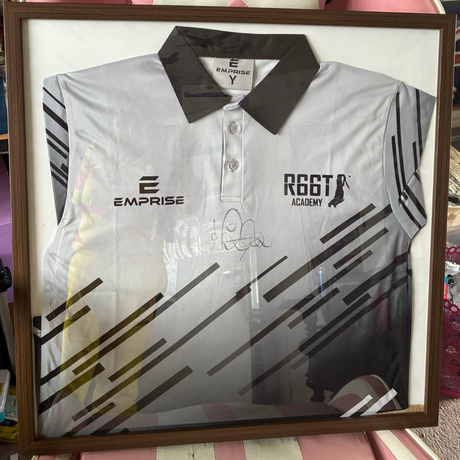 Membership prize features a grey R66T Academy Polo Shirt signed by Joe Root in a frame