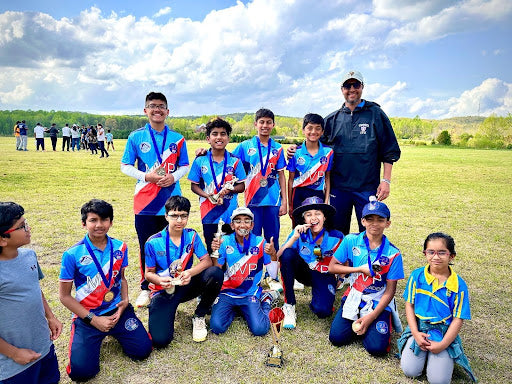 MVP Cricket Academy in kit on a field with a blue sky.