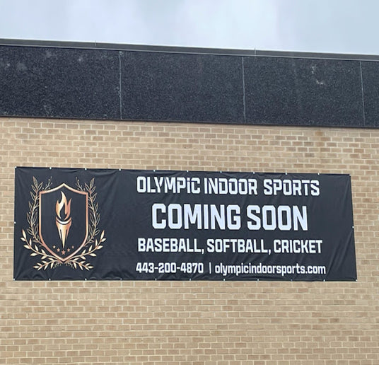 Banner for Olympic Indoor Sports on a brick wall