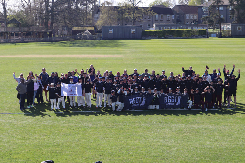 Large group of people on a soccer field holding banners