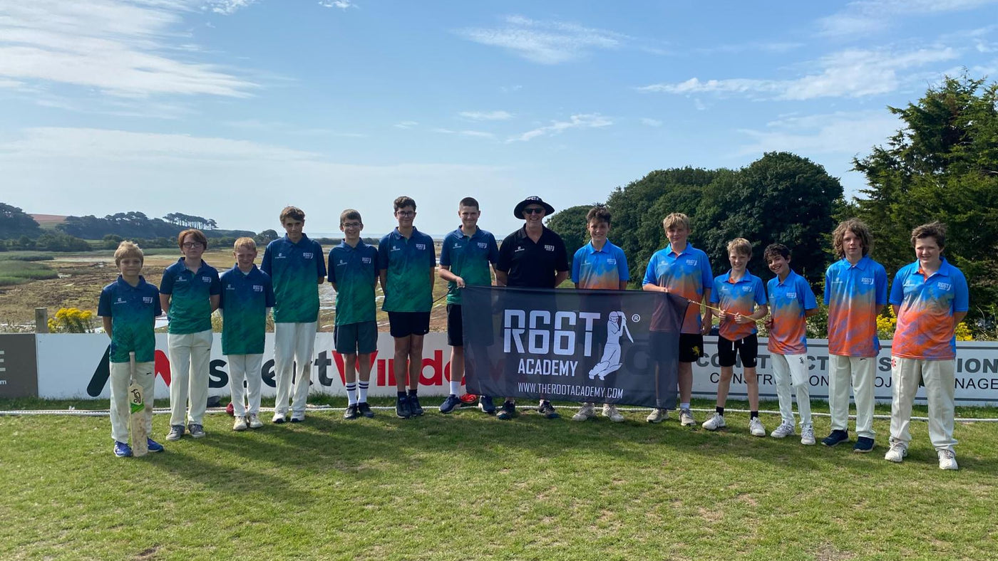 2 Teams holding the R66T Academy flag outside
